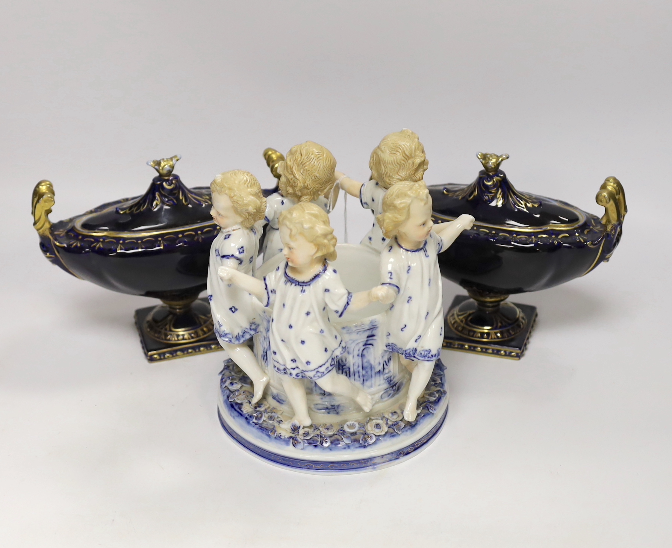 A Volkstedt porcelain figure group of children dancing together with two urns and covers (3), figure group 8cm